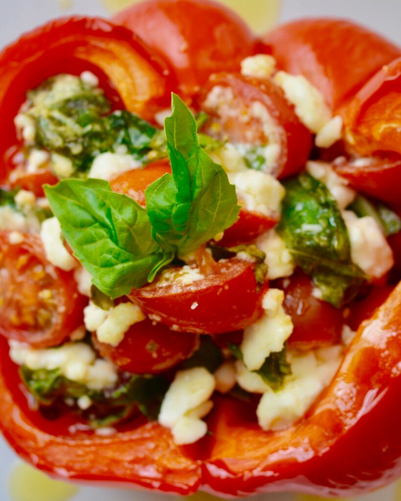 Healthy Italian Stuffed Peppers | Gluten Free Vegetarian appetizer or lunch. So fresh and delicious and easy to throw together. Cherry tomatoes, feta cheese, basil and olive oil stuffed into a red pepper and heated through. Absolutely delicious!