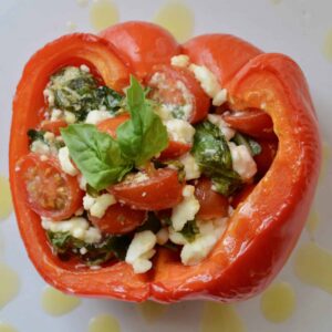 Italian Stuffed Peppers - full of fresh tomatoes, basil and feta. Drizzled with olive oil and salt. So amazing and so simple! Perfect appetizer for your next Italian meal.