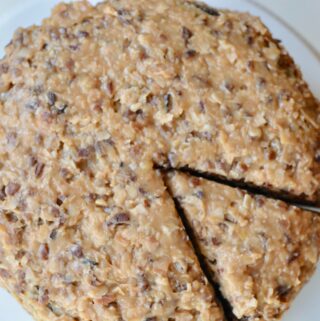 Perfectly dense German Chocolate Cake. Made with chocolate chips, plenty of coconut and pecans. Perfect for a birthday or any celebration!