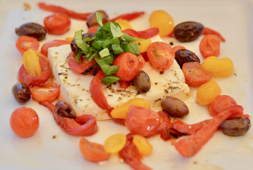 Baked Feta with Tomatoes, Olives, Red Pepper and Basil, Herbs and Olive Oil. Serve with homemade baked pita chips!