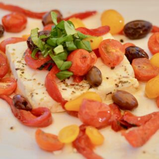 Baked Feta with Tomatoes, Olives, Red Pepper and Basil, Herbs and Olive Oil. Serve with homemade baked pita chips!