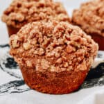 Close up of pumpkin muffin with crumb topping.