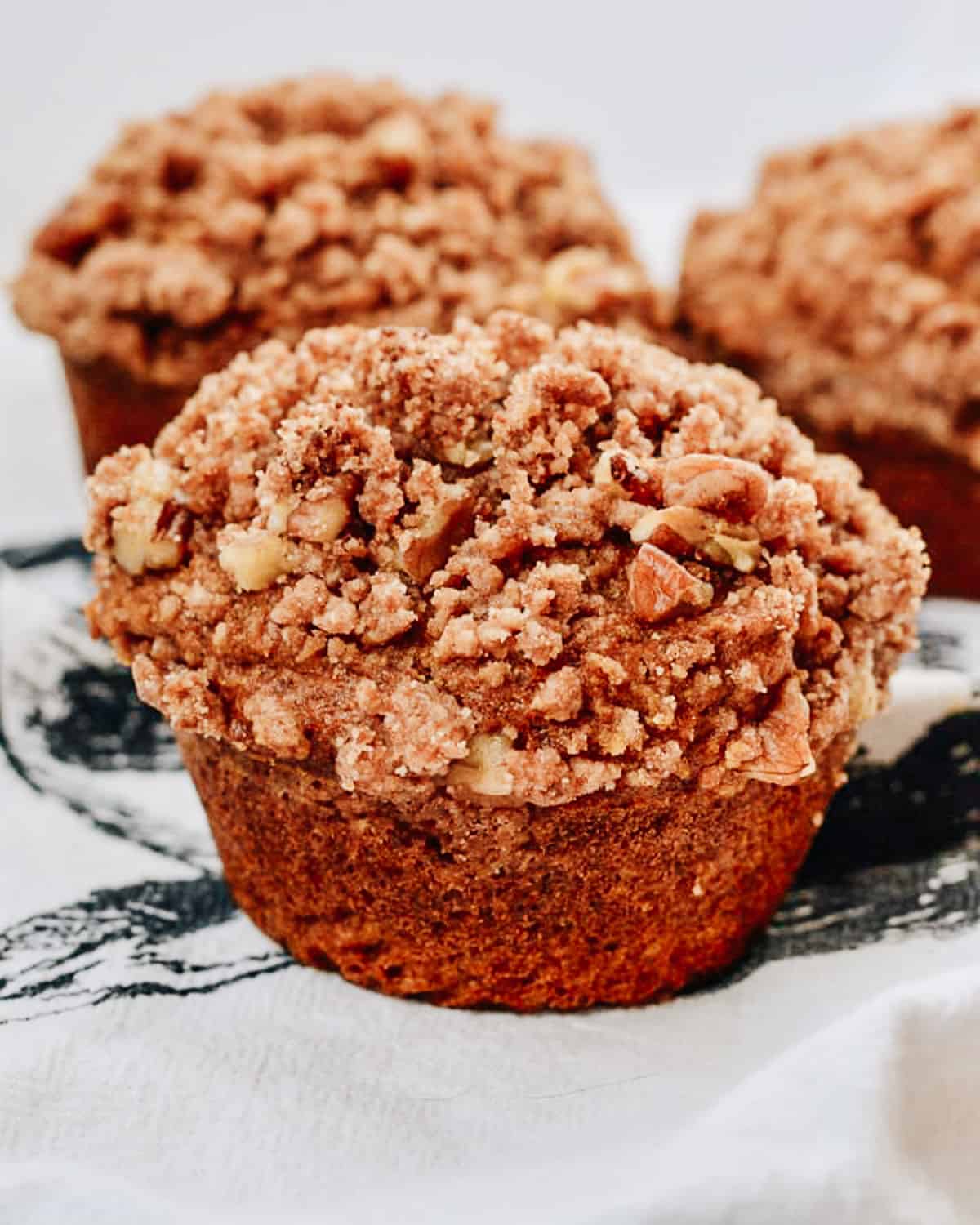 Close up of pumpkin muffin with crumb topping.