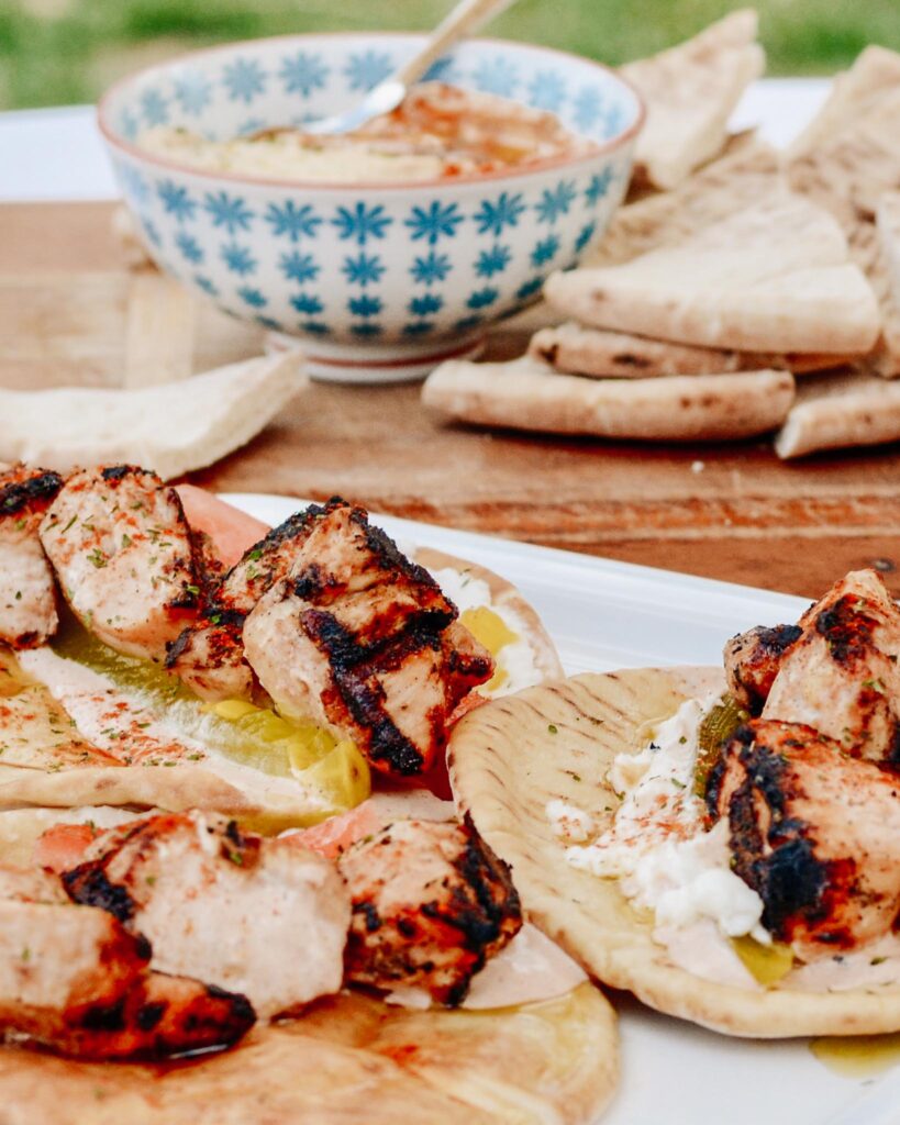 Chicken Tawook Pita Sandwich - Lebanese flavors with grilled chicken, perfectly spiced marinade and sauces, along with tomatoes, pickles and packed with tons of authentic, but easy flavor. #tawook #lebanese #chickendinner