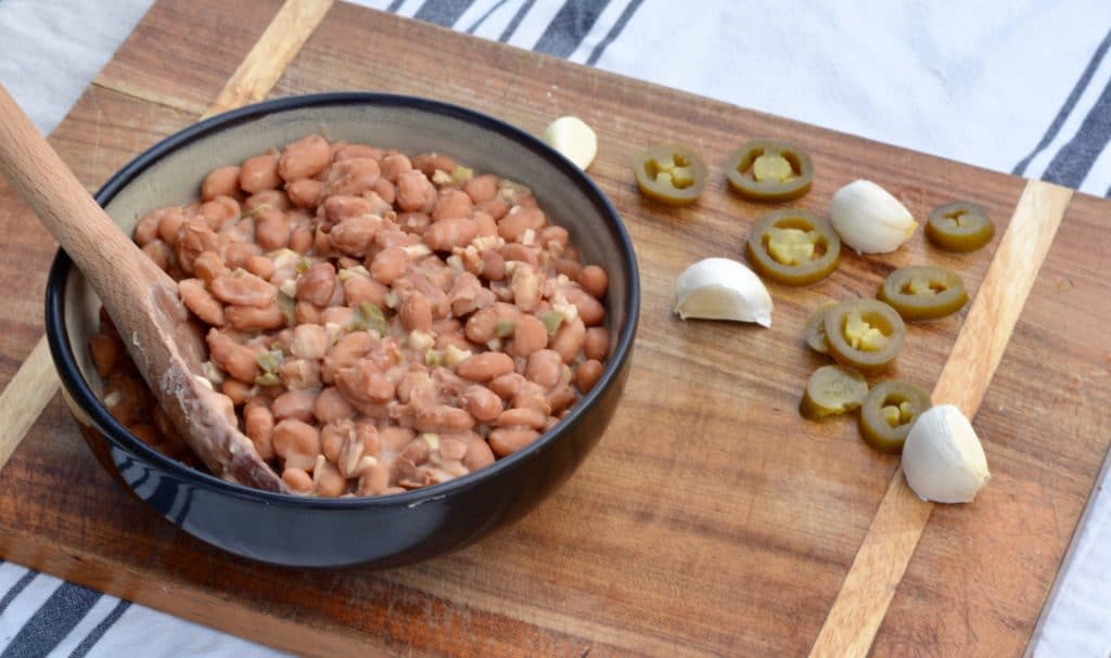 Garlic Jalapeño Pinto Beans - restaurant quality with only a few minutes of hands-on time. Delicious vegetarian side dish for any meal!