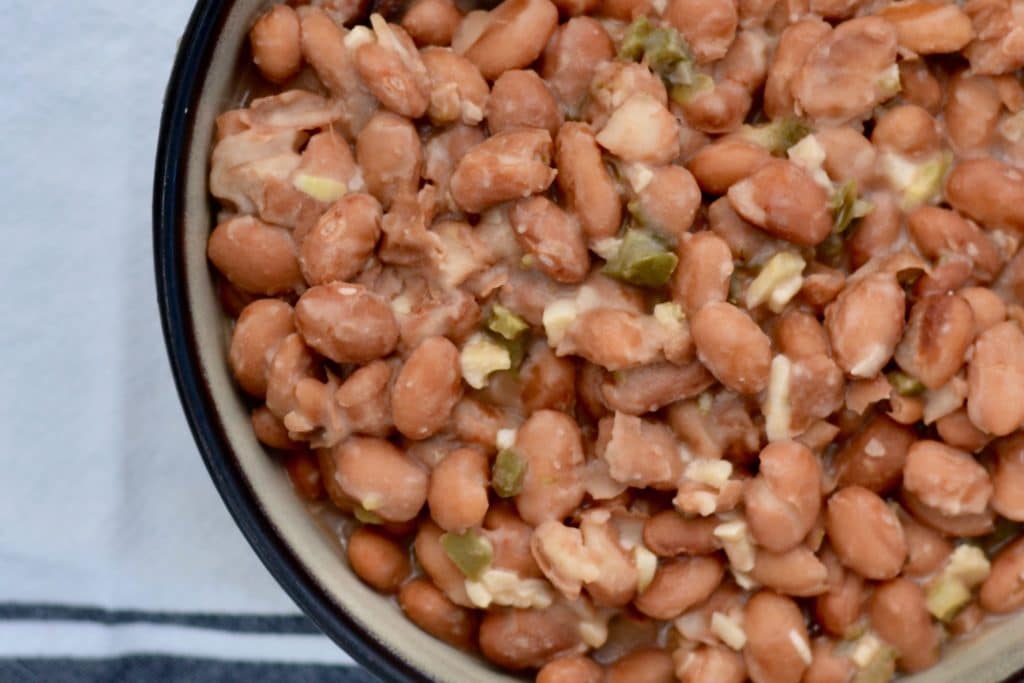 Garlic Jalapeño Pinto Beans - restaurant quality with only a few minutes of hands-on time. Delicious vegetarian side dish for any meal!