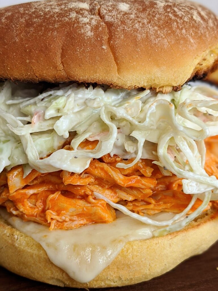 Buffalo Chicken and Blue Cheese Slaw Burger - pulled chicken with homemade blue cheese dressing. Seriously delicious and so simple! Great to make ahead.