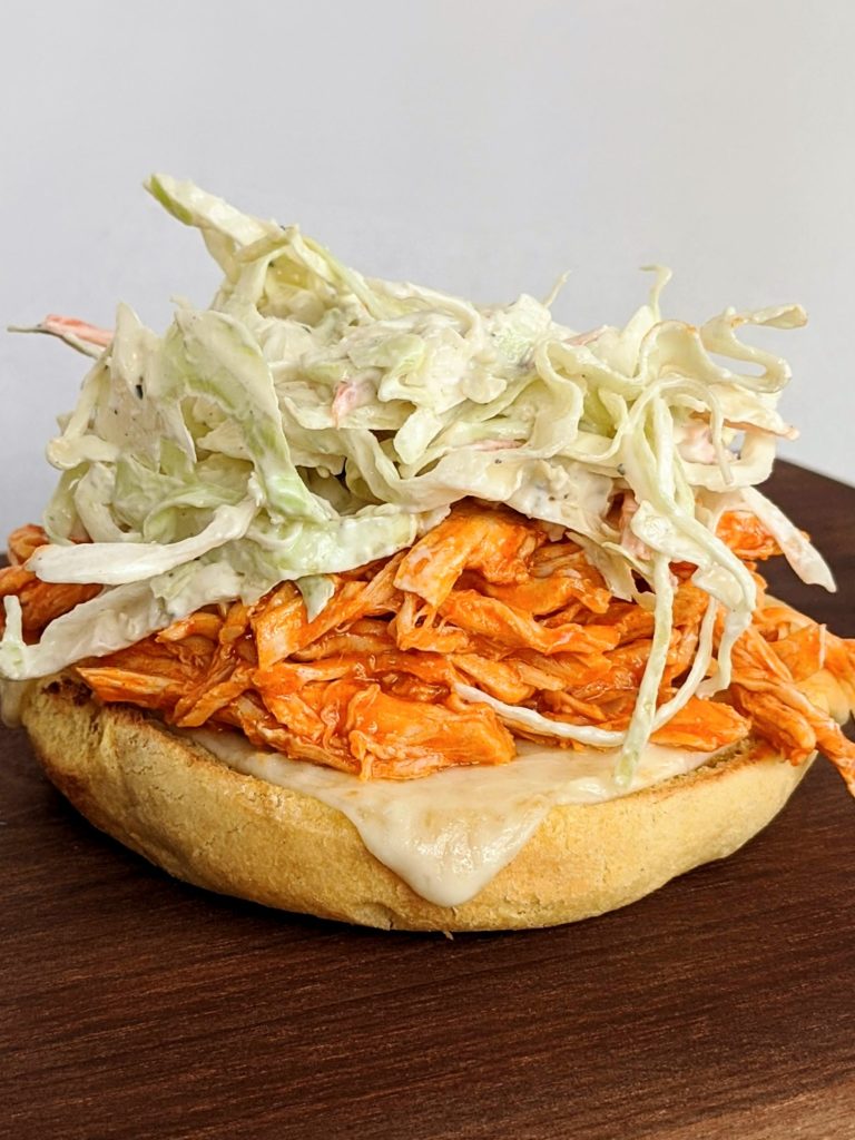 Buffalo Chicken and Blue Cheese Slaw Burger - pulled chicken with homemade blue cheese dressing. Seriously delicious and so simple! Great to make ahead.