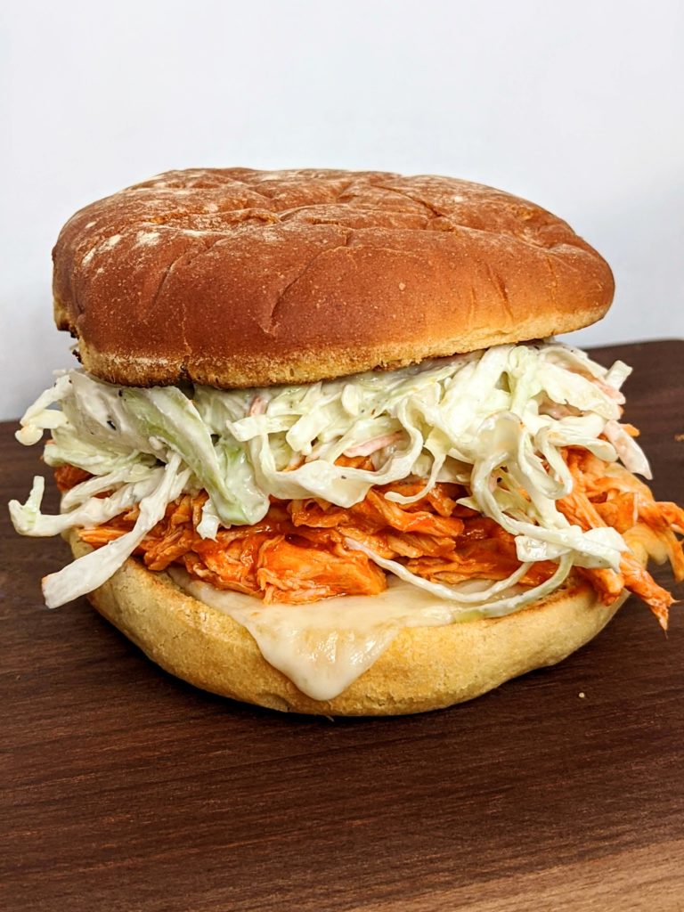 Buffalo Chicken and Blue Cheese Slaw Burger - pulled chicken with homemade blue cheese dressing. Seriously delicious and so simple! Great to make ahead.