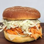 Buffalo Chicken and Blue Cheese Slaw Burger - pulled chicken with homemade blue cheese dressing. Seriously delicious and so simple! Great to make ahead.