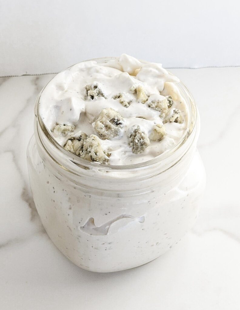 The BEST homemade Blue Cheese Dressing and Dip. A secret ingredient sets it apart from the rest and takes this blue cheese dressing to a whole other level! Perfect for dipping chips, fries, or on top of salad.
