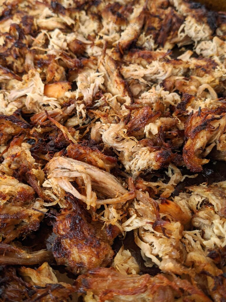 Carnitas made so full of flavor and so simple to make in a slow cooker or crock pot. Coca cola, orange juice, onion and spices flavor our pork shoulder or butt. YUM!