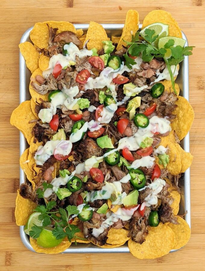 Simple Carnitas Nachos perfect for Sunday night dinner. LOVE each delicious topping: Jalapeño Pinto Beans, Easy Carnitas and Monterey Jack Queso!