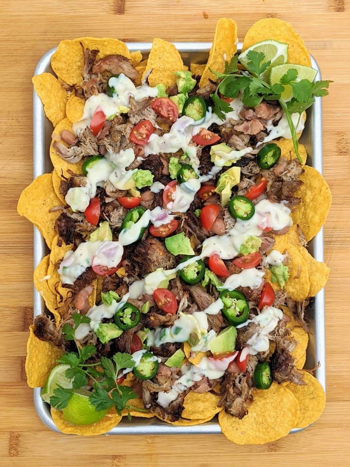 Simple Carnitas Nachos perfect for Sunday night dinner. LOVE each delicious topping: Jalapeño Pinto Beans, Easy Carnitas and Monterey Jack Queso!