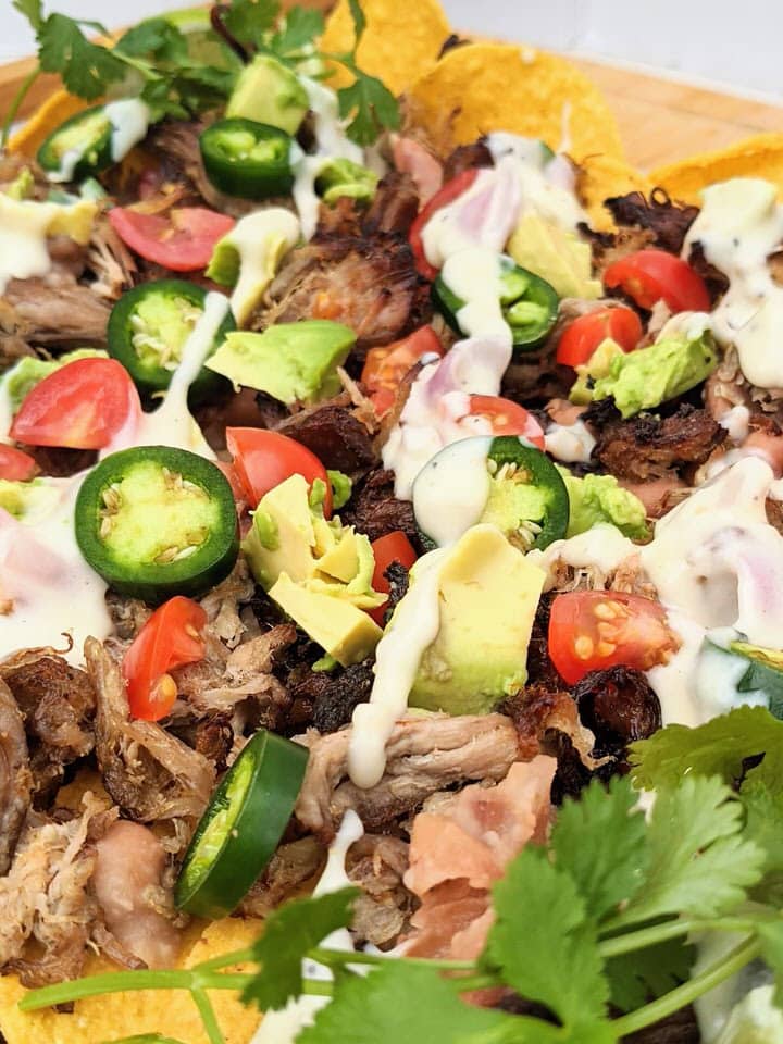 Simple Carnitas Nachos perfect for Sunday night dinner. LOVE each delicious topping: Jalapeño Pinto Beans, Easy Carnitas and Monterey Jack Queso!