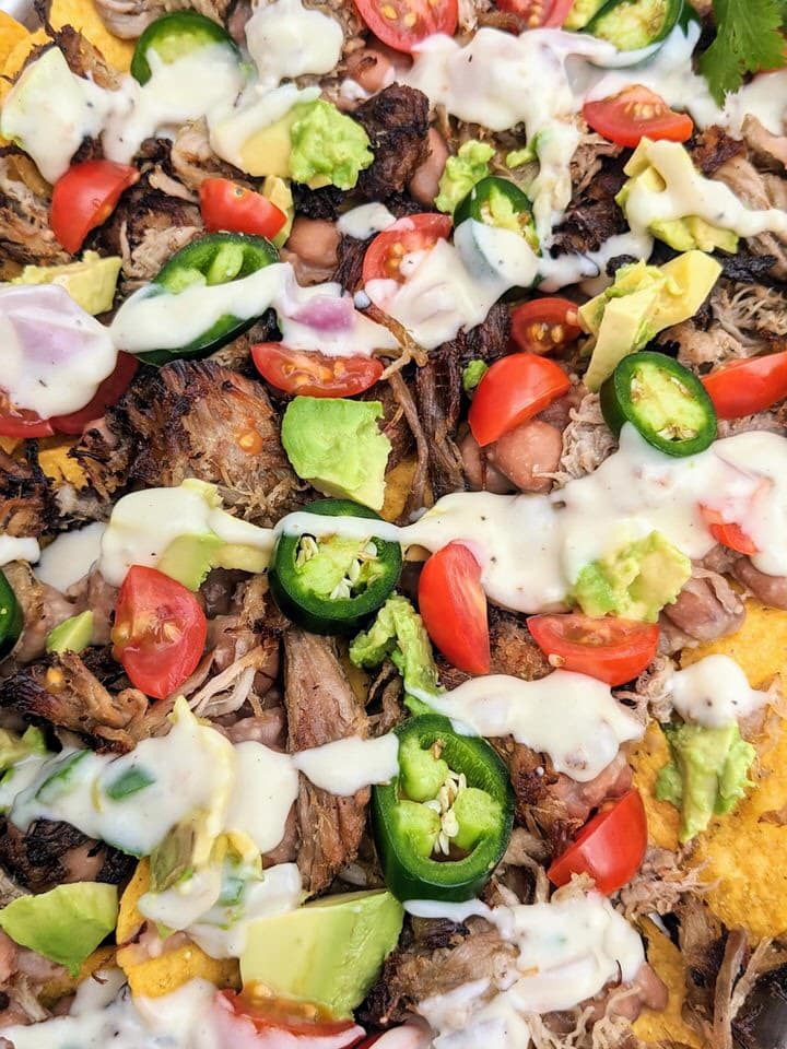 Simple Carnitas Nachos perfect for Sunday night dinner. LOVE each delicious topping: Jalapeño Pinto Beans, Easy Carnitas and Monterey Jack Queso!