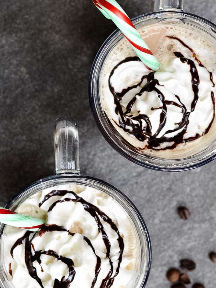 Top view of whip cream and chocolate sauce on mocha's with candy canes.