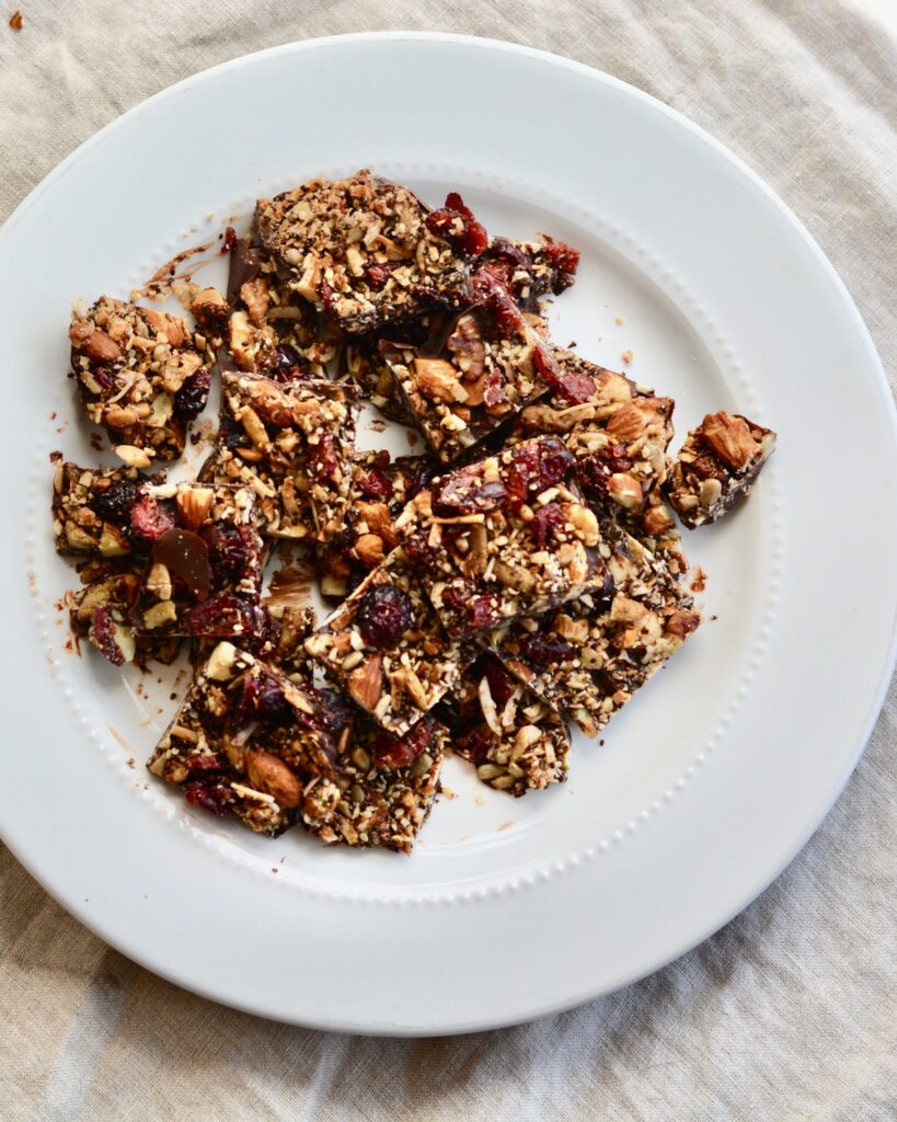 Grain Free Granola and Cranberry Chocolate Bark | Perfect Holiday Snack or Gift. Dark chocolate topped with lightly sweetened grain free granola and dried cranberries. Delicious!