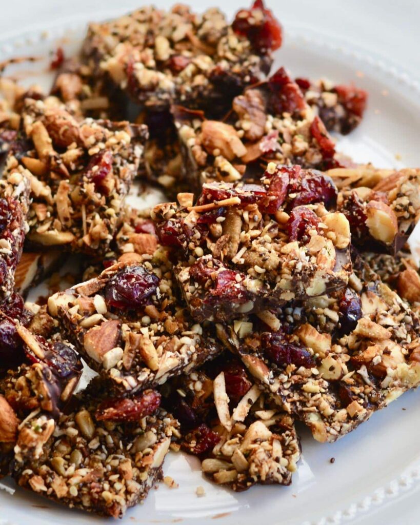Grain Free Granola and Cranberry Chocolate Bark | Perfect Holiday Snack or Gift. Dark chocolate topped with lightly sweetened grain free granola and dried cranberries. Delicious!
