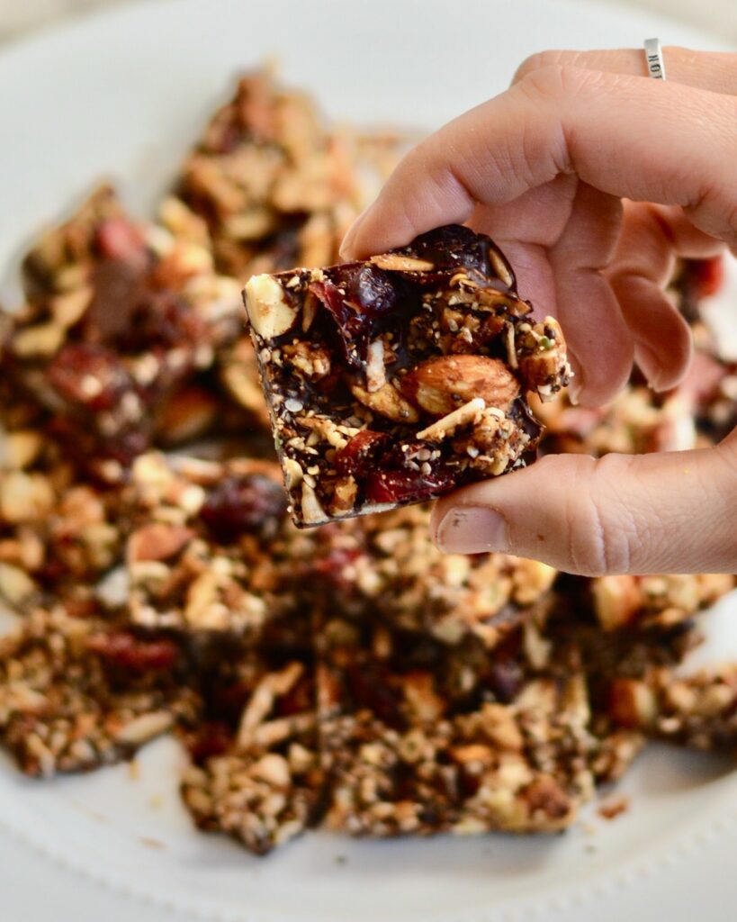 Grain Free Granola and Cranberry Chocolate Bark | Perfect Holiday Snack or Gift. Dark chocolate topped with lightly sweetened grain free granola and dried cranberries. Delicious!