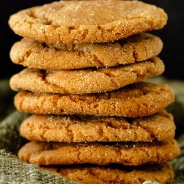 Close up of molasses cookies on green fabric.