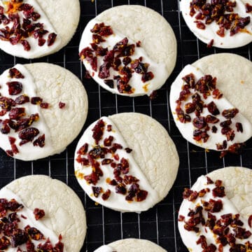 White chocolate dipped cookies on a cooling rack.