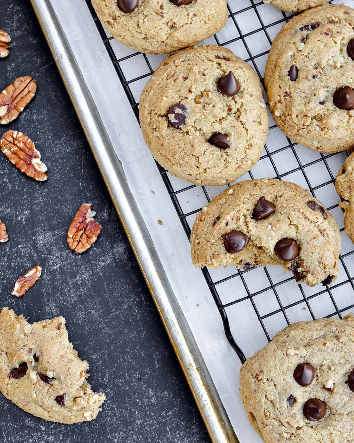 Cookies on a cooling rack with more cookies next.