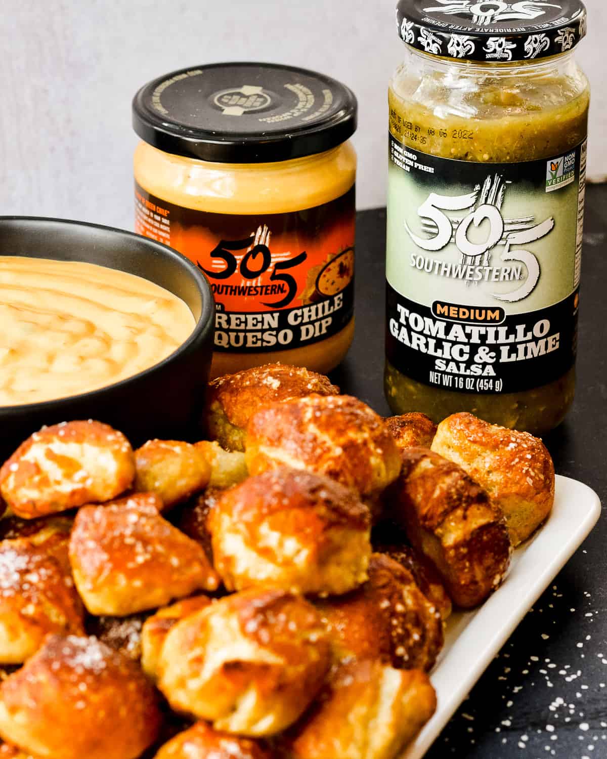 Pretzel bites with 505 southwestern tomatillo and queso jars in background.
