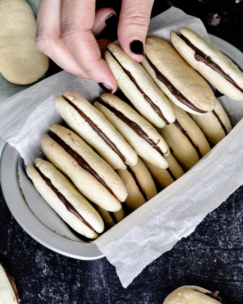 Copycat Milano Cookies | Gluten free and Dairy free. Perfectly crispy cookie with dark chocolate filling. Very simple recipe.