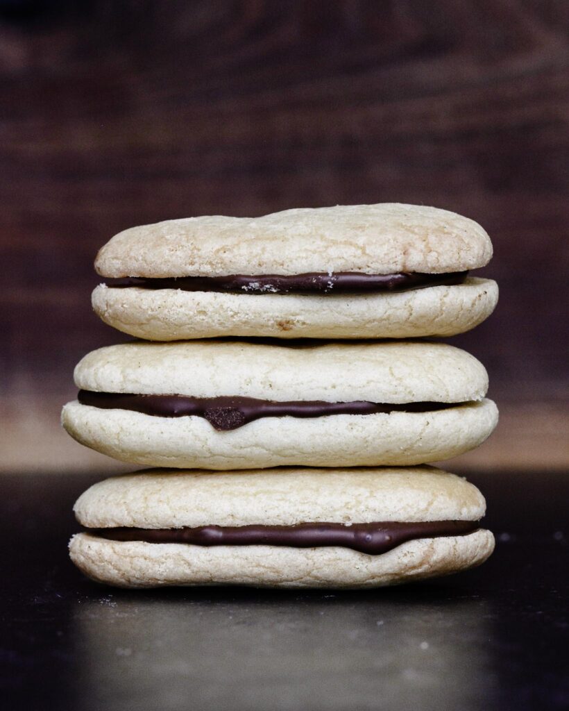 Copycat Milano Cookies | Gluten free and Dairy free. Perfectly crispy cookie with dark chocolate filling. Very simple recipe.