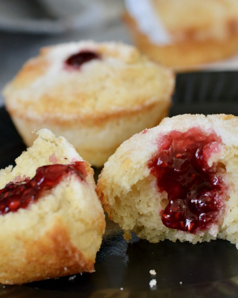 Sweet Donut Muffins made gluten free in this simple one bowl recipe. Why have just a muffin, when you can have a donut muffin? Filled with raspberry jam and relaxing moments. Perfect grab and go breakfast the whole family will treasure.