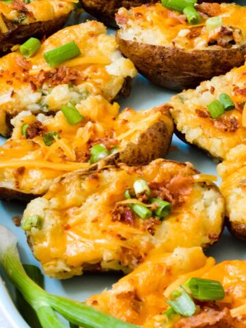 Fully Loaded Twice Baked Potatoes | Stuffed with cream cheese, cheddar, bacon, green onion and TONS of flavor. The perfect summer appetizer or side dish.