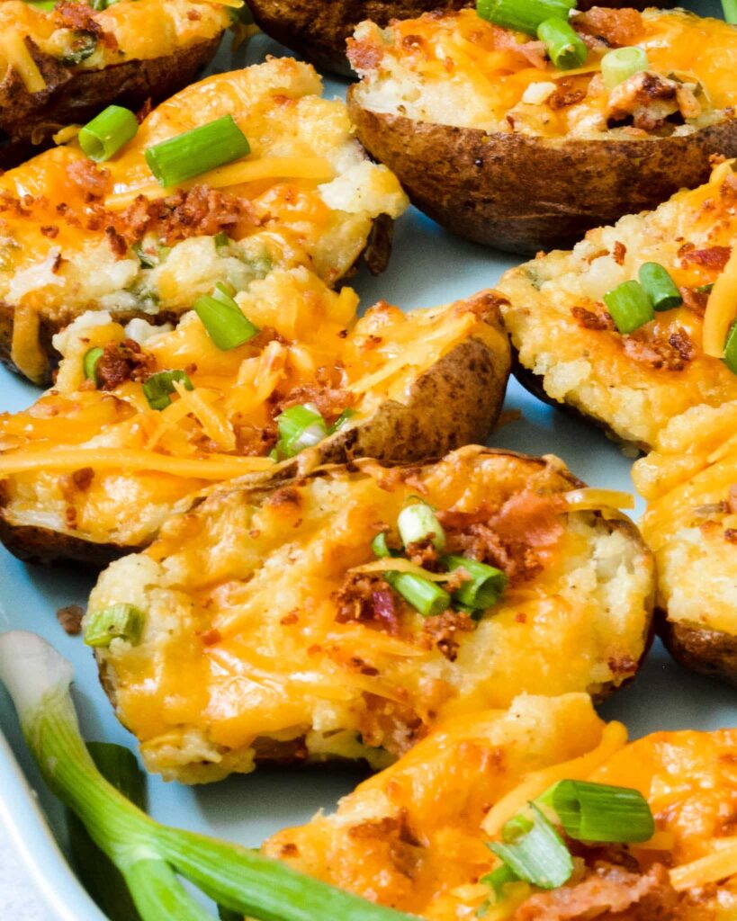 Fully Loaded Twice Baked Potatoes | Stuffed with cream cheese, cheddar, bacon, green onion and TONS of flavor. The perfect summer appetizer or side dish.