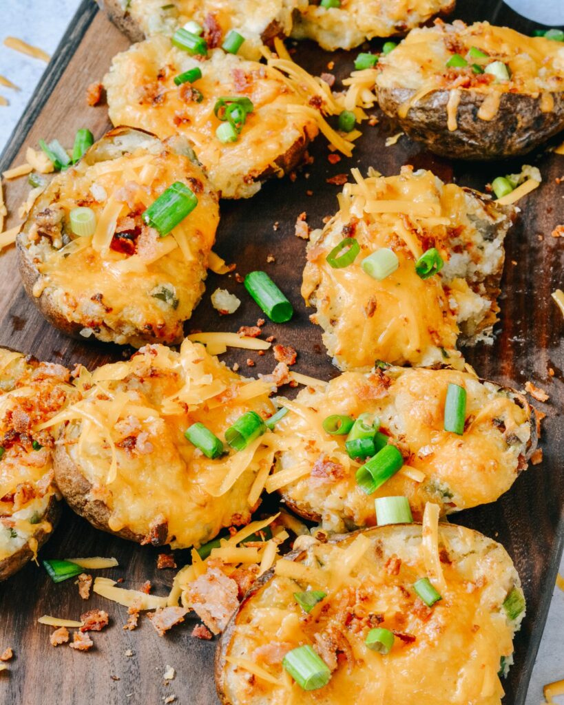 Fully Loaded Twice Baked Potatoes | Stuffed with cream cheese, cheddar, bacon, green onion and TONS of flavor. The perfect summer appetizer or side dish.