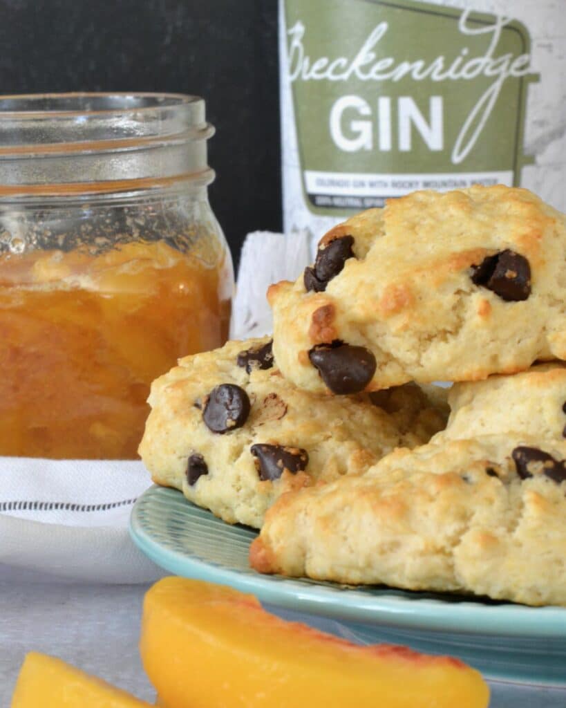 A twist on classic Peaches and Cream Shortbread with a splash of Breckenridge Gin. Tender and soft chocolate chip biscuits with homemade peach sauce and homemade whip cream. The BEST summer dessert!