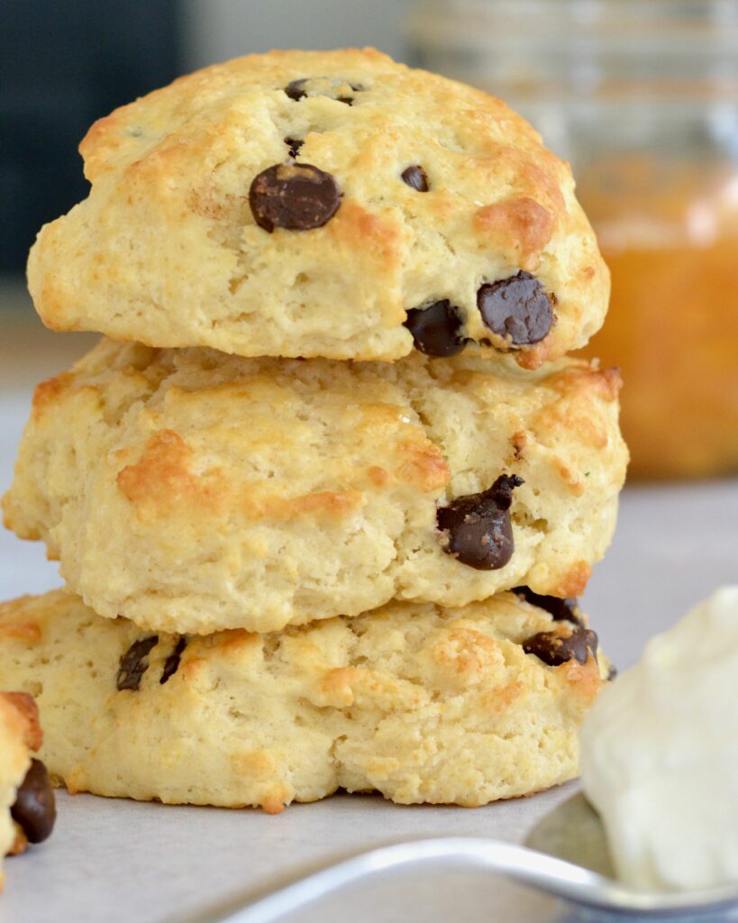 A twist on classic Peaches and Cream Shortbread with a splash of Breckenridge Gin. Tender and soft chocolate chip biscuits with homemade peach sauce and homemade whip cream. The BEST summer dessert!