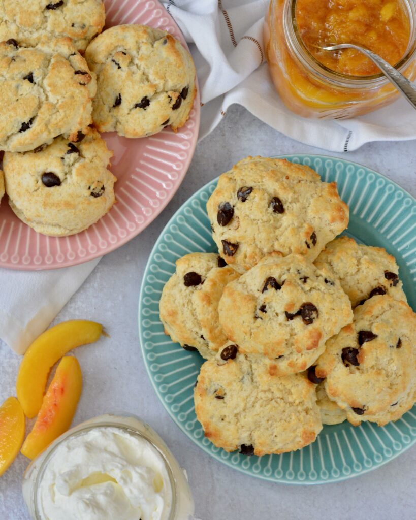 A twist on classic Peaches and Cream Shortbread with a splash of Breckenridge Gin. Tender and soft chocolate chip biscuits with homemade peach sauce and homemade whip cream. The BEST summer dessert!