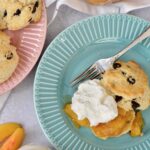 A twist on classic Peaches and Cream Shortbread with a splash of Breckenridge Gin. Tender and soft chocolate chip biscuits with homemade peach sauce and homemade whip cream. The BEST summer dessert!