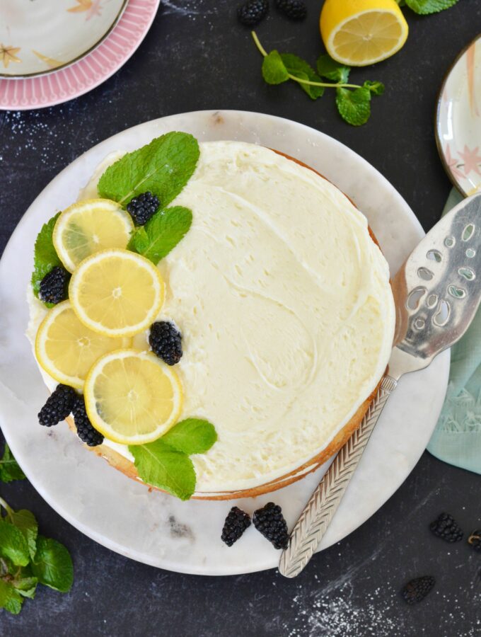 Lemon Layer Cake for the win! The perfect summer dessert. So festive and beautiful. The perfectly light, fluffy cake, layered with lemon buttercream and lemon curd. Add blackberries or any summer fruit for a delightful summer flavor. Gluten Free Option.