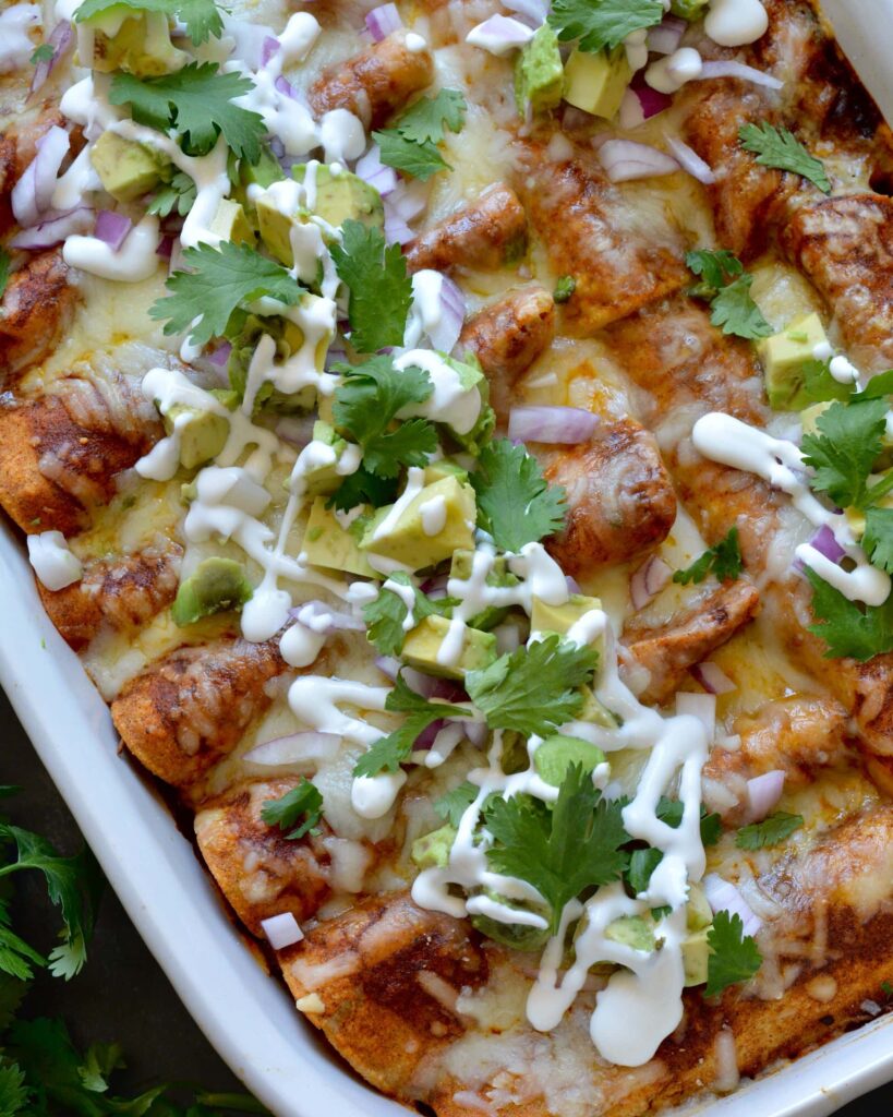 Delicious Make Ahead Enchiladas filled with Carnitas, Black Beans and Sweet Potatoes. Outstanding flavor combination of sweet, savory and spice. Simple homemade enchilada sauce recipe too!