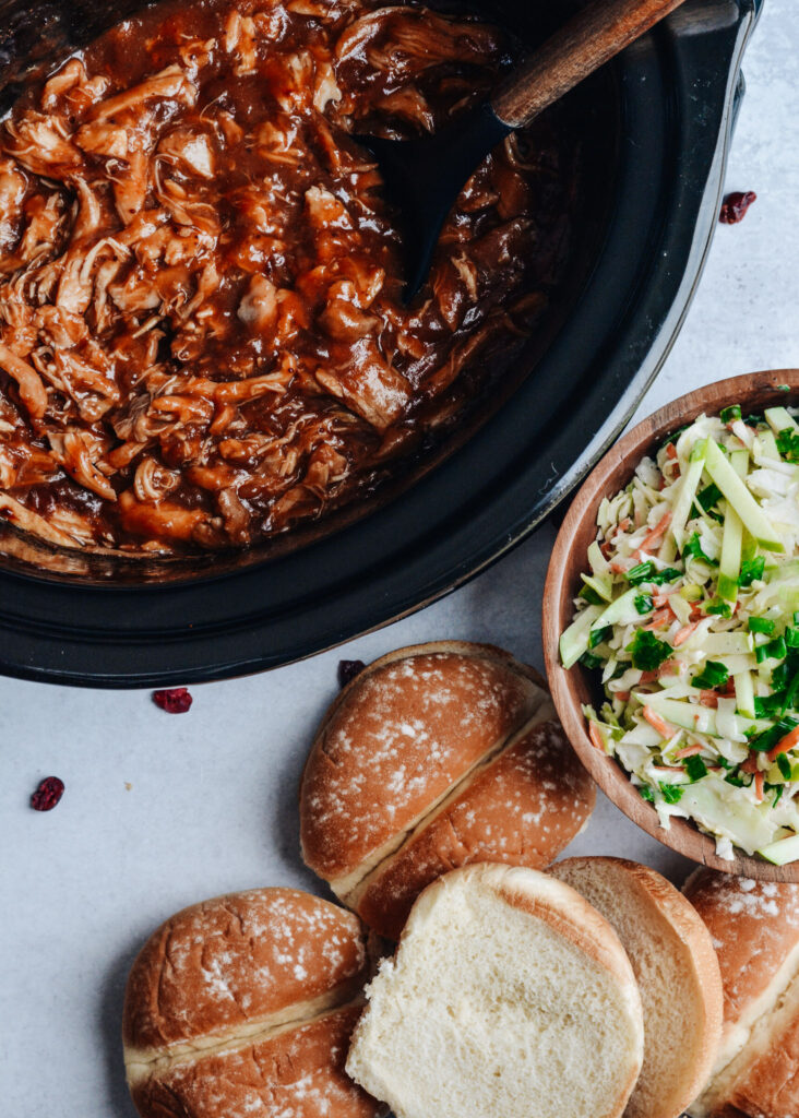 Cranberry BBQ Pulled Pork with Apple Slaw - slow cooker chicken thighs and make ahead slaw cuts dinner prep time to a minimum. Completely delicious meal the whole family will love!