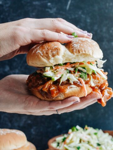 Cranberry BBQ Pulled Pork with Apple Slaw - slow cooker chicken thighs and make ahead slaw cuts dinner prep time to a minimum. Completely delicious meal the whole family will love!