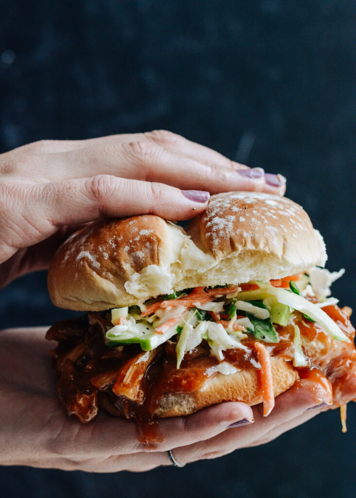 Cranberry BBQ Pulled Chicken with Apple Slaw - slow cooker chicken thighs and make ahead slaw cuts dinner prep time to a minimum. Completely delicious meal the whole family will love!