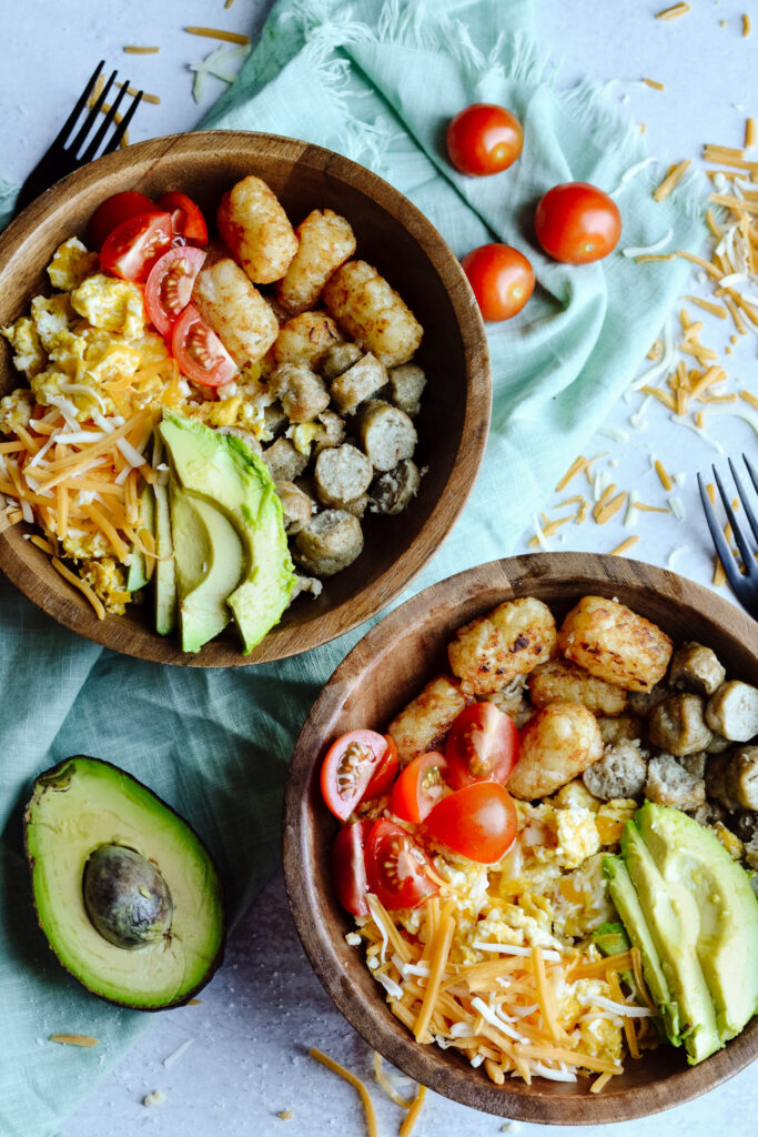 Simple Breakfast Hash—Perfect brunch hash, scrambled eggs, tater tots, cheese, avocado, sausage and toppings.