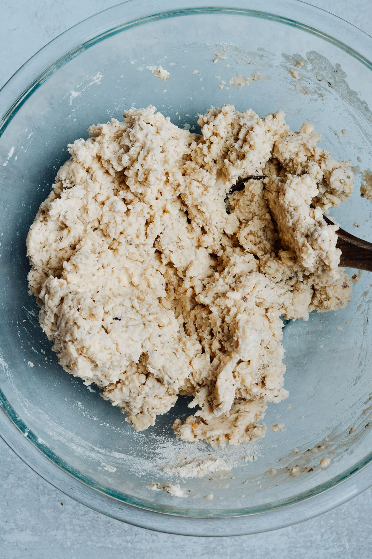 Mixed biscuit dough in glass bowl.