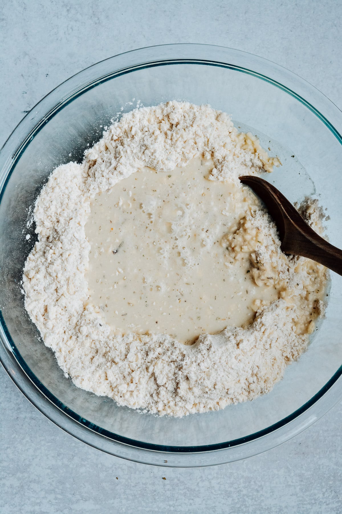 Bowl of butter and flour mixture with milk in center.