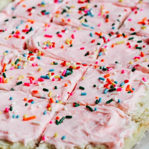 Soft and sweet with a delicate crumb, these Sugar Cookie Bars are made with a simple replacement gluten free flour. Topped with a not-too-sweet frosting and decorated with sprinkles. Kids and adults will love it! #sugarcookie #cookiebars #kidfriendly