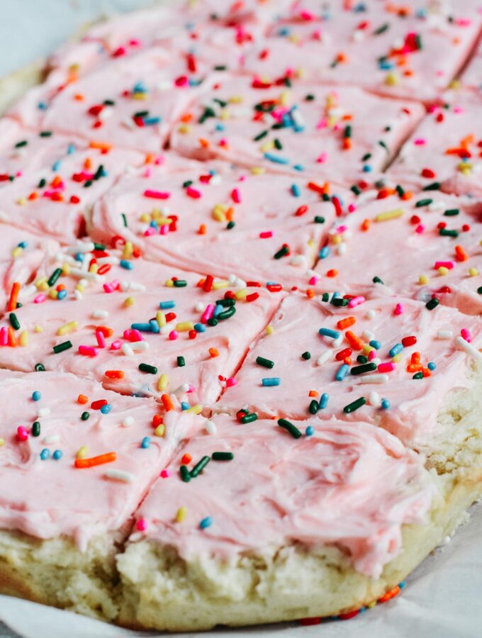 Soft and sweet with a delicate crumb, these Sugar Cookie Bars are made with a simple replacement gluten free flour. Topped with a not-too-sweet frosting and decorated with sprinkles. Kids and adults will love it! #sugarcookie #cookiebars #kidfriendly