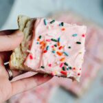 Soft and sweet with a delicate crumb, these Sugar Cookie Bars are made with a simple replacement gluten free flour. Topped with a not-too-sweet frosting and decorated with sprinkles. Kids and adults will love it! #sugarcookie #cookiebars #kidfriendly