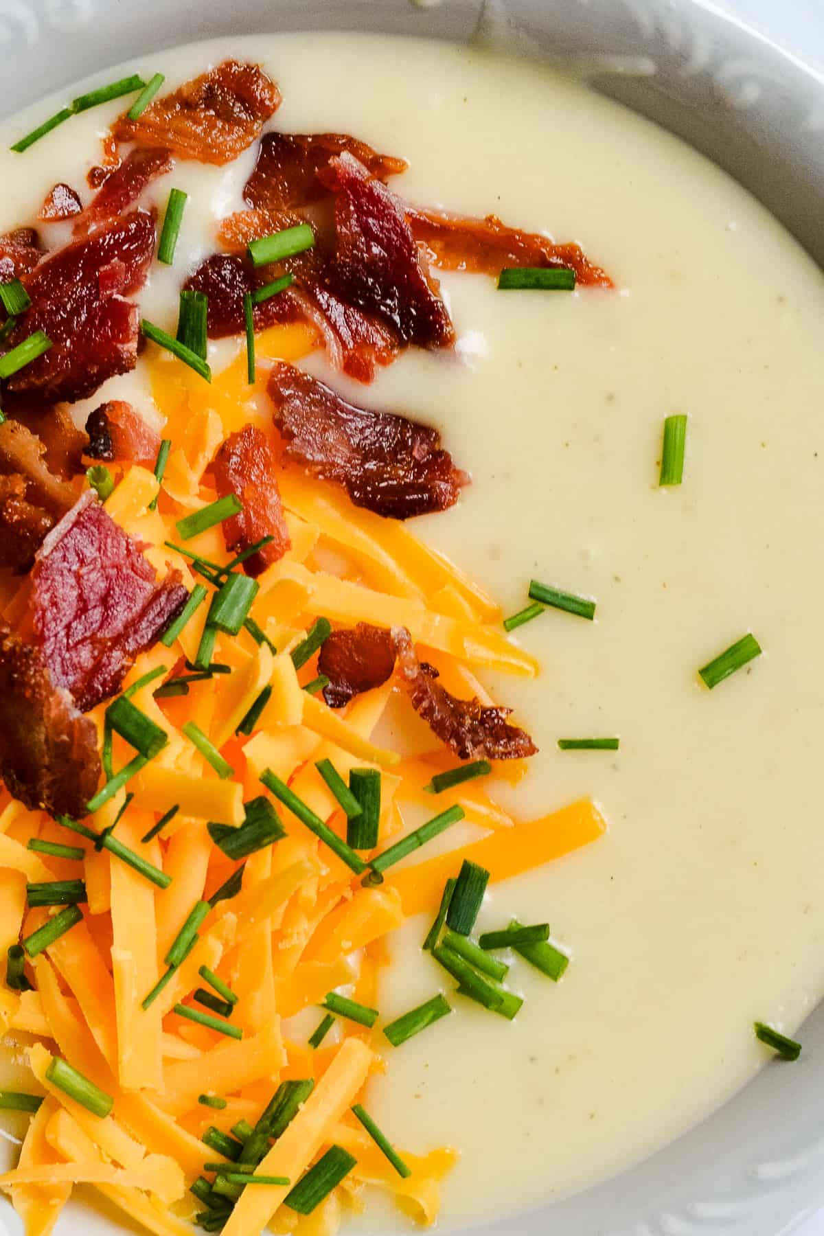 Close up of baked potato soup with toppings.